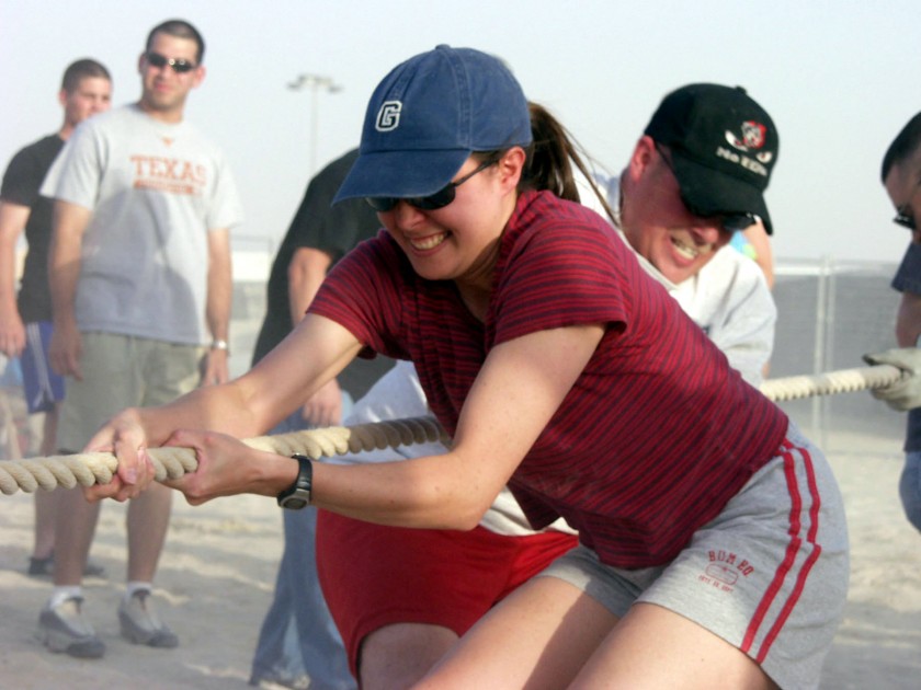 OPERATION IRAQI FREEDOM -- First Lt. Theresa Weihrich grimaces as she helps her 386th Expeditionary Communications Squadron teammates win a tug-of-war contest May 26 during the Iraqi Freedom Festival at a forward-deployed air base. Weihrich is deployed from Mountain Home Air Force Base, Idaho. The 386th Expeditionary Services Squadron sponsored the event that featured a variety of morale-boosting contests and activities for airmen, soldiers, sailors and Marines. (U.S. Air Force photo by Tech. Sgt. Dan Neely)