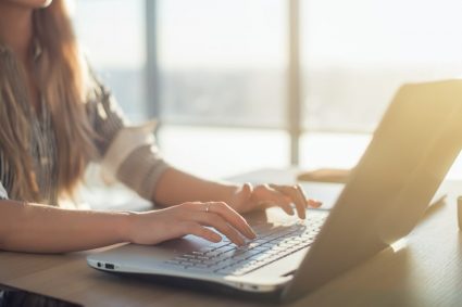 A young female student writing a blog