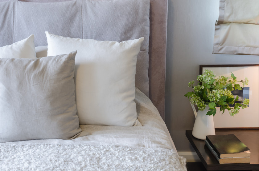 Flowers in a vase on a bedside table