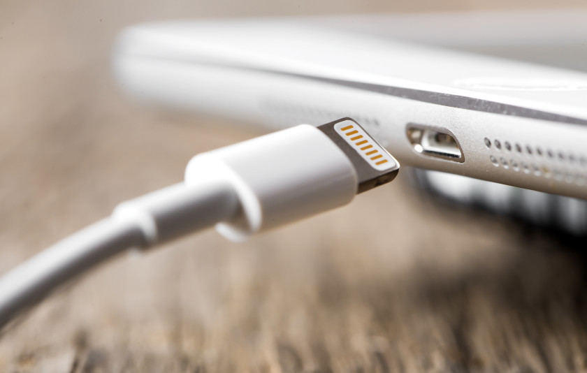 A closeup image of a phone and a phone charger