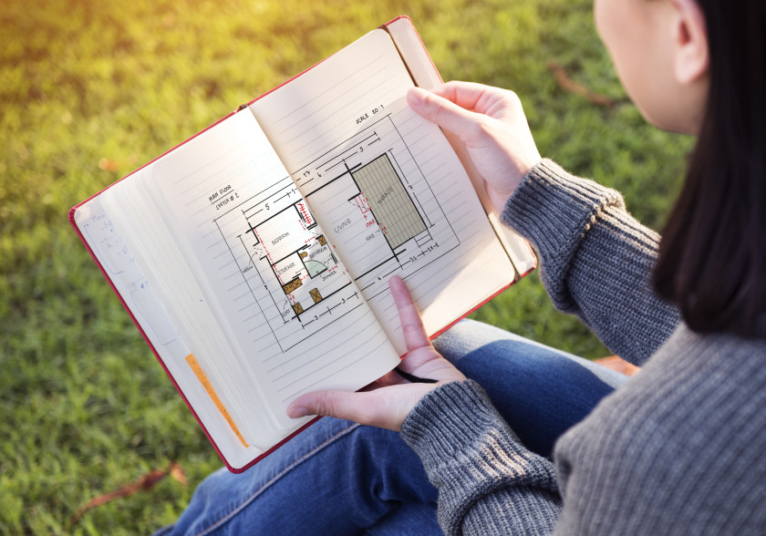 A female student looking at her architecture notebook