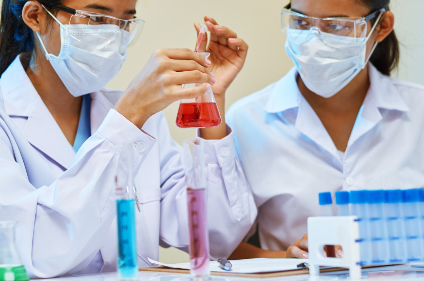 Two chemical engineering students working in a lab