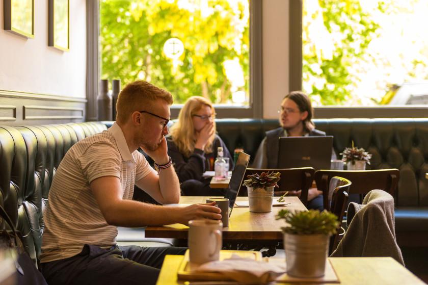 Economics students studying on a couch