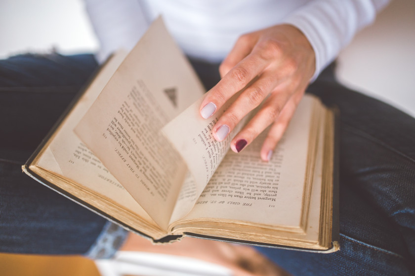 An English literature student reading a book