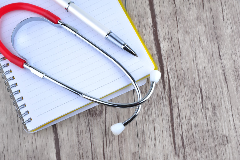 A stethoscope, a pen and a notebook