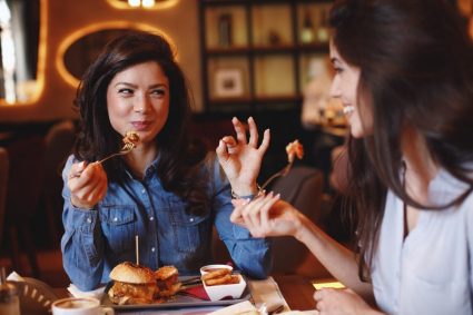 Two female students eating dinner together