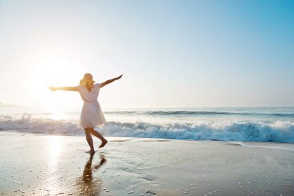 A young woman having fun on the beach