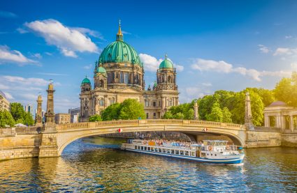 A riverboat on the Spree River in front of the Berlin Cathedral