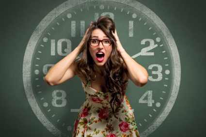 A panicked-looking woman in front of a large clock