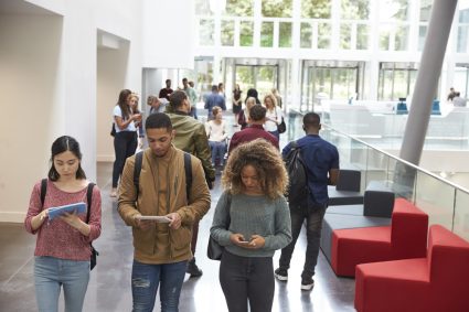 Students using their phones in a university campus