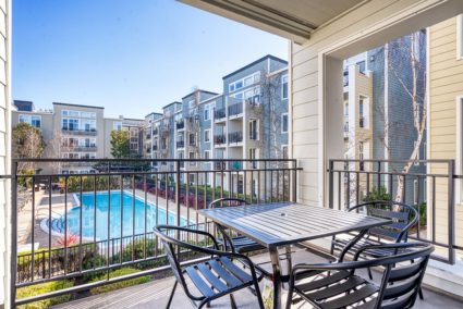 A balcony and a pool at The Courtyards at 65th Street Apartments in Berkeley