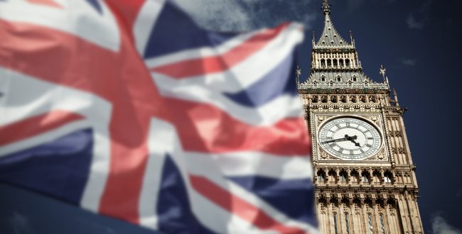 A Union Jack in front of the Big Ben in London