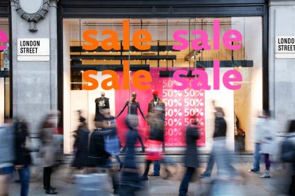 A shop with large "Sale" signs on the window