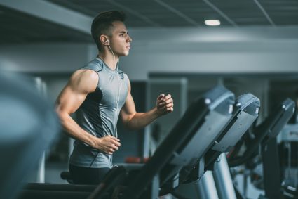 A young man exercising on a treadmill