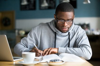 A young man practising for an exam