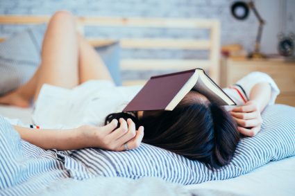 A stressed student lying on a bed