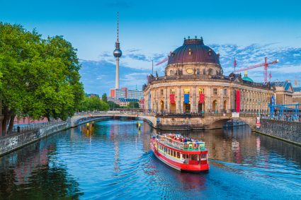 A riverboat on the Spree River in Berlin, with the Fernsehturm in the background