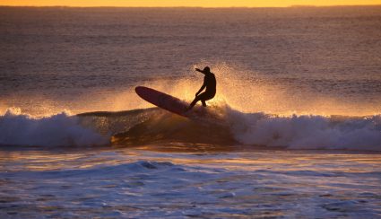 A surfer at dusk