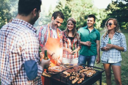 A group of young people barbecuing