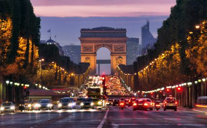 Champs-Elysees at night, with the Arc de Triomphe in the background