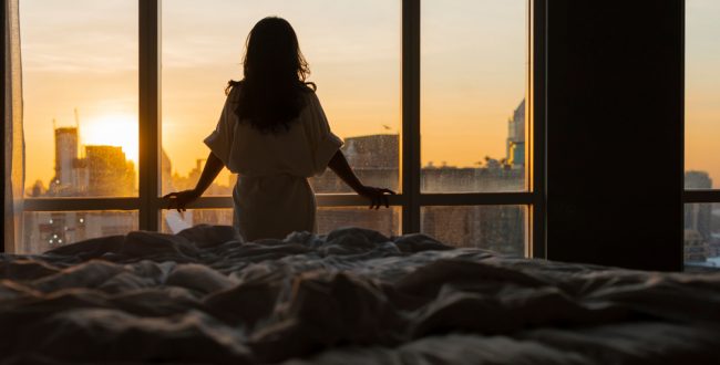 A woman enjoying the view from the apartments she's viewing