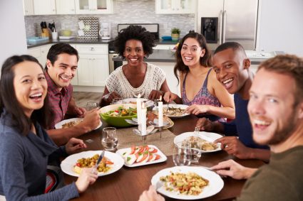 A group of young people eating together in their student accommodation