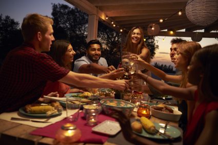 A group of young people eating out together