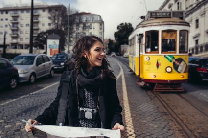 A young woman exploring a city with a map