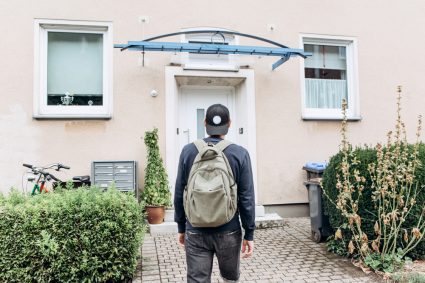 A young student moving into student accommodation