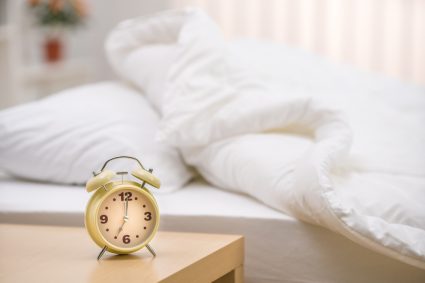 An alarm clock on a bedside table