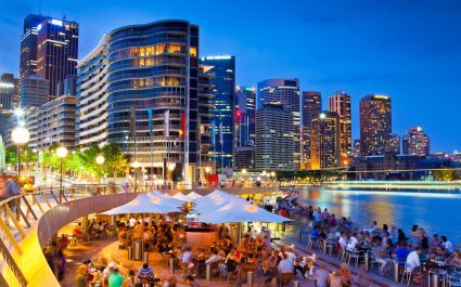 Lots of people drinking outside on a seaside bar