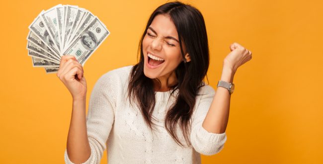 A woman excited about having saved lots of money
