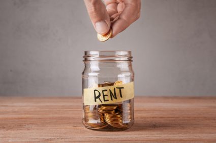 A jar of coins with the text "rent" written on it