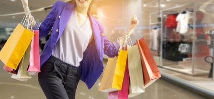 A woman with lots of shopping bags on both arms