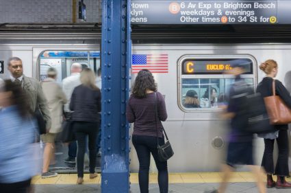 People boarding at a train at the New York City Subway