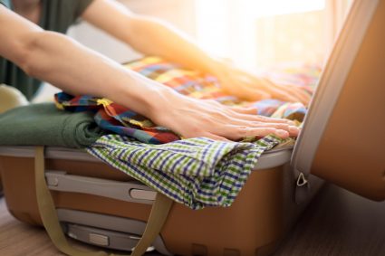 A student packing a suitcase