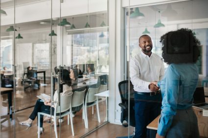 Young professionals shaking hands with each other