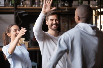 A group of friends exchanging high fives