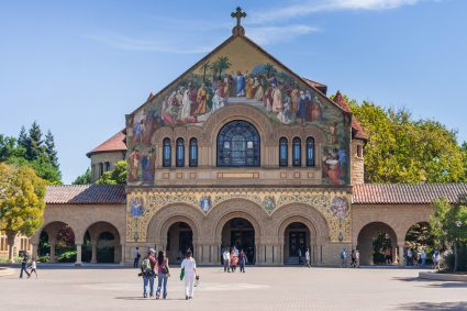 A building and some students at the Stanford University campus