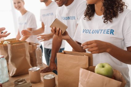 A group of students handing out food bags