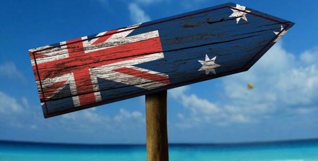 A sign painted in the colours of the Australian flag on a beach